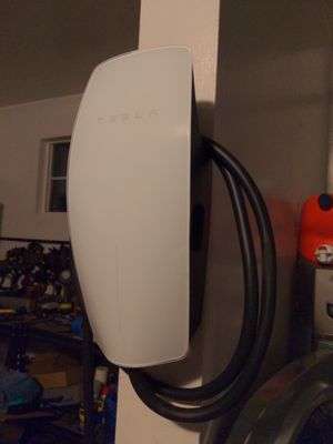 Tesla Wall Connector installed on a garage wall by Silva Electric